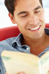 Young man reading a book