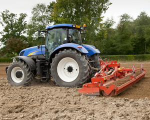 Naklejka premium Blue Tractor Pulling Power Harrow
