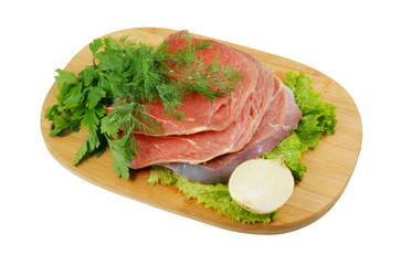 Raw beef meat with fresh vegetables on wooden cutting board