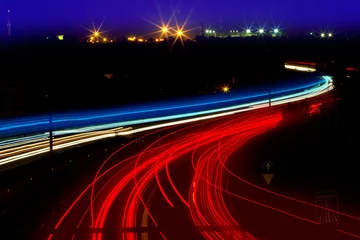 Wall murals Highway at night car light trails in red and white on night road