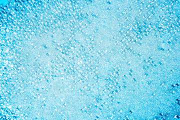Fototapeta na wymiar crystal glass pearls little balls texture on blue