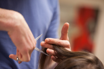 Obraz na płótnie Canvas Close up of a masculine hand cutting hair