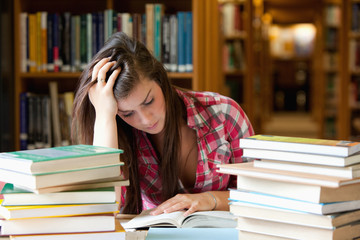 Focused student surrounded by books