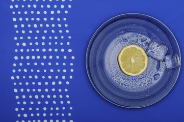 Fresh lemon on the blue plate