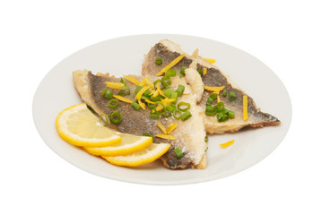 Two pieces of fried fish and lemon segment