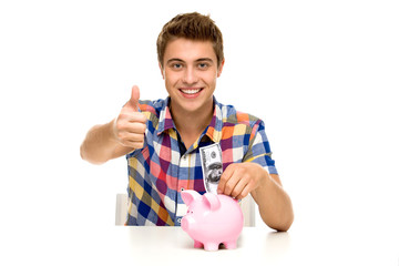 Man with piggy bank showing thumbs up