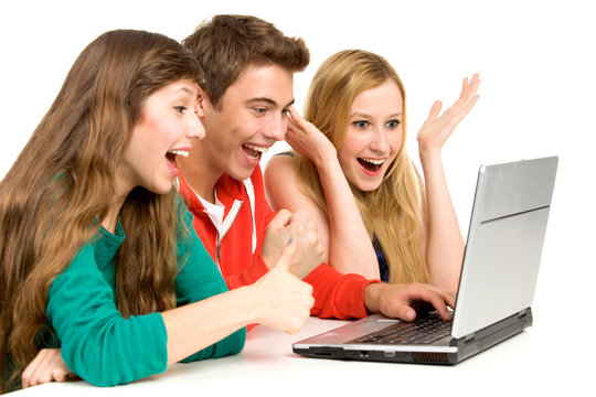 Amazed young people with laptop
