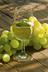 wine and grapes on wooden table