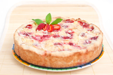 Strawberry pie decorated with ripe strawberry, mint and almond f