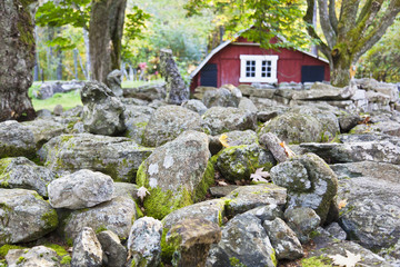 Stone wall with red barn