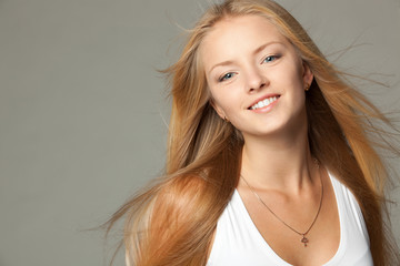 Fototapeta premium Close up portrait of smiling beautiful blond female
