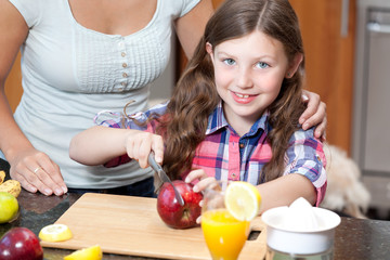 Little girl cuts apple