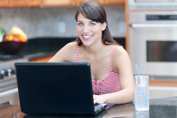 Hispanic woman using laptop computer