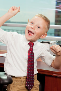 Cute Boy With Goofy Face In Business Attire In An Office