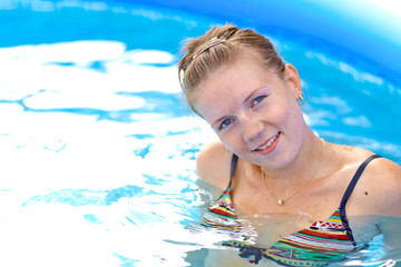 Fototapeta na wymiar Young pretty girl smiling in pool