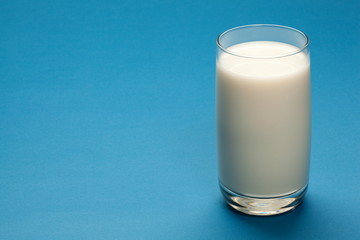 Glass of milk on a blue