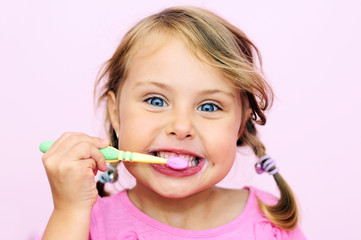 A young girl brushing her teeth