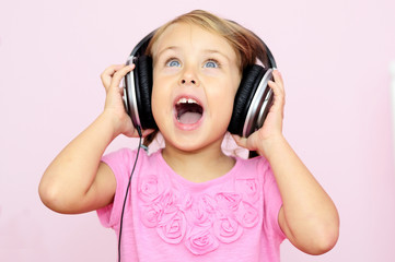 little girl singing in headphones