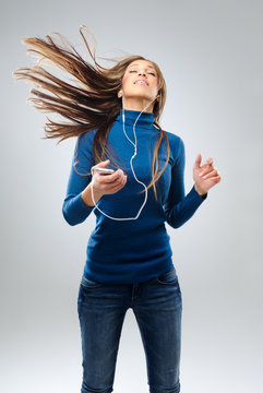 Happy woman with music player