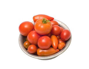 Tomatoes in an aluminum bowl, isolated on white.