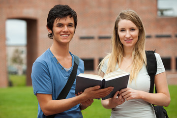 Cute couple holding a book