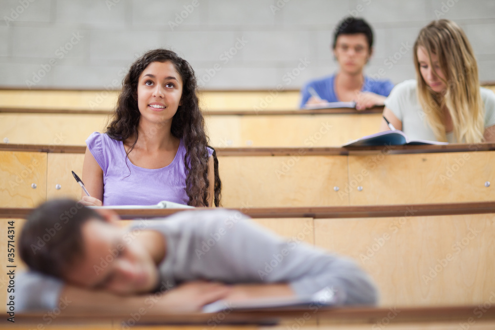 Poster students listening while their classmate is sleeping