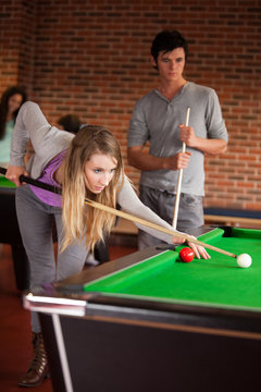 Portrait of young friends playing snooker