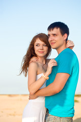 Fototapeta na wymiar couple embracing on beach