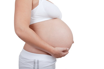 Pregnant woman hold hands on a belly