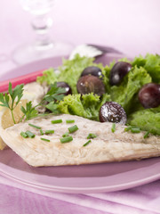 mackerel fillet with salad and slice grapes over lilac table