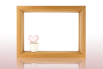 wood frame and crstal heart  on white background with reflection