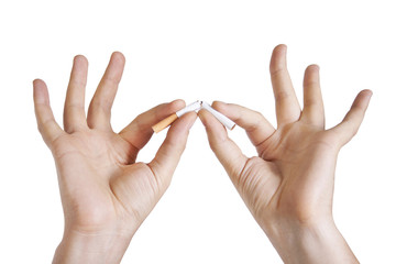Man’s hand breaking a cigarette