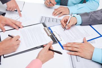 Business people in elegant suits sitting at desk handshake