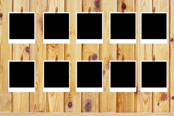 set of ten old blank polaroids frames lying on a wood surface