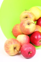 Fresh green, red apples in basket isolated