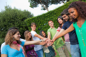 Happy Teenage Group with Hands on Stack