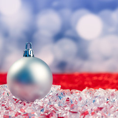 Christmas silver bauble on ice cubes