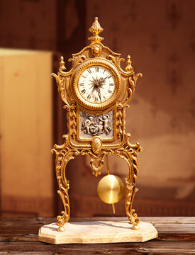 ancient vintage golden brass pendulum clock