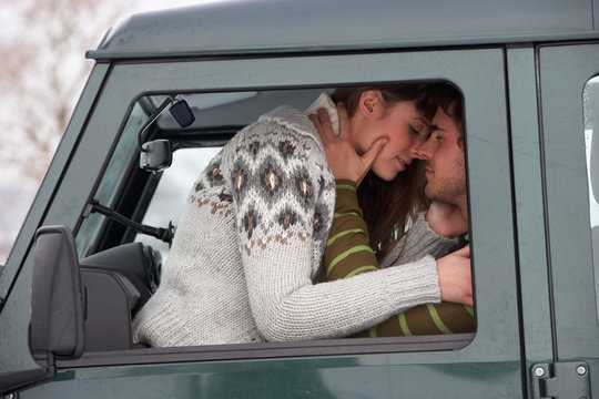 Young Couple In Car In Snow