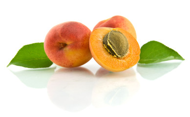 apricots with green leaf isolated on white background