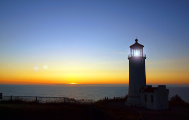 Fototapeta na wymiar Light Shining in the North Head Lighthouse at Sunset