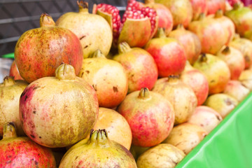 Row of pomegranate fruits.