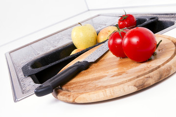 Apples and tomatoes prepared in the kitchen.