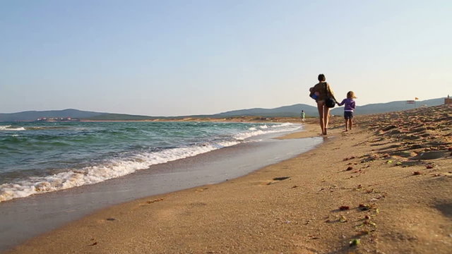 Walk on seacoast, Mother and daughter