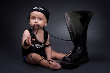 dark portrait of  rocker-baby on a black background