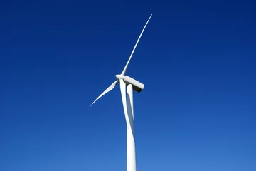 Papier Peint photo Moulins Wind turbine against blue sky