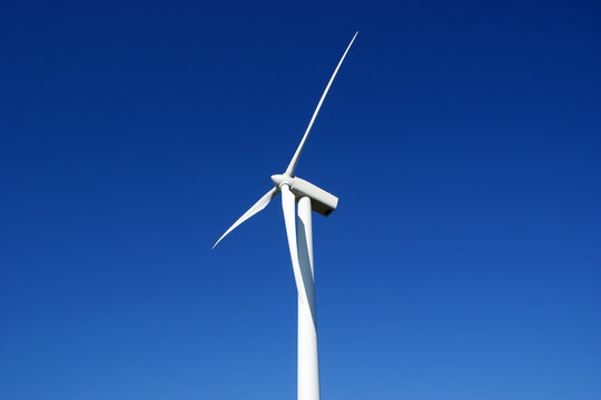 Wind turbine against blue sky