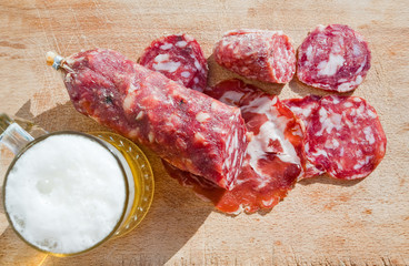 italian salami and glass of beer outdoor