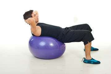 Man doing abs on pilates ball