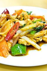 Stir fry chicken and chili in oil